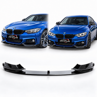 Load image into Gallery viewer, A black front splitter lip spoiler shown below two blue BMW cars, with the cars used as styling references on a clean white background.
