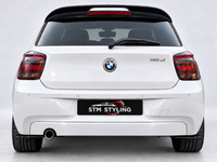 Load image into Gallery viewer, Rear view of a white BMW 116d hatchback with a black rear spoiler and a black license plate frame reading 'STM STYLING'.
