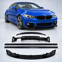 Load image into Gallery viewer, A blue BMW coupe is shown in the background, with a set of black aftermarket aerodynamic body kit parts laid out in the foreground on a light gray studio background. The parts include a rear spoiler, front splitter, lip, and two side skirts. F32 F36 4 Series Gloss Black Body Kit
